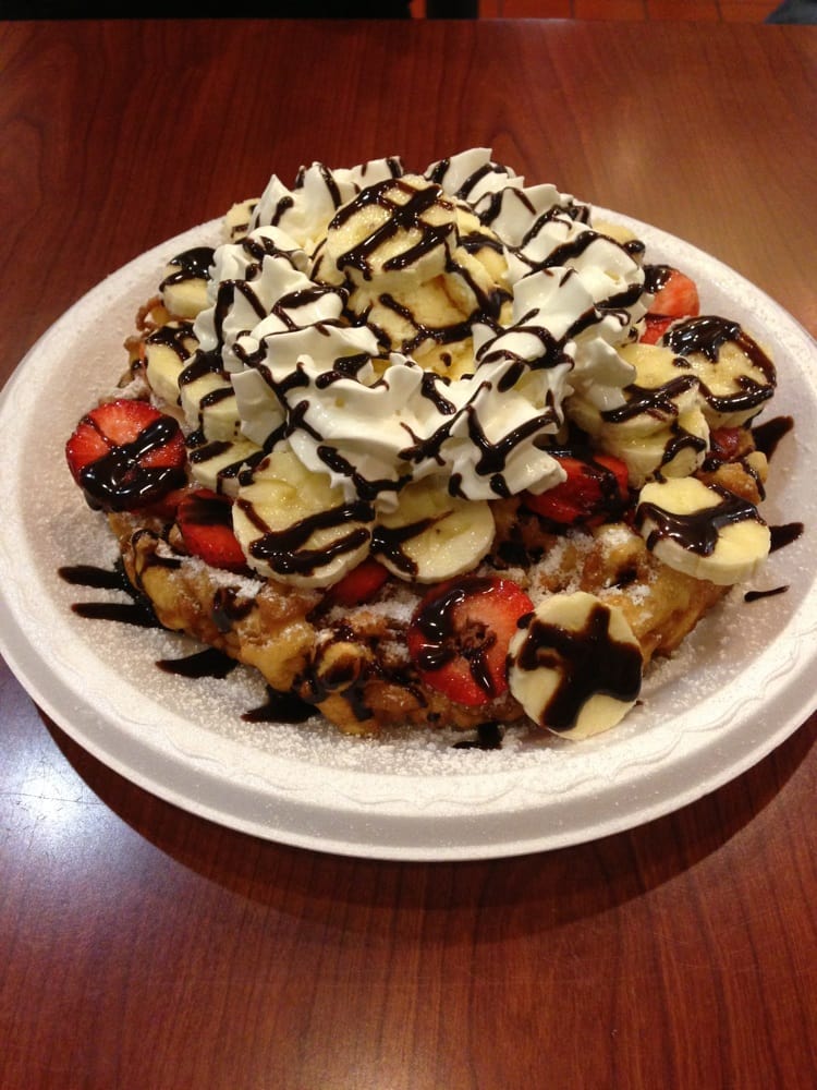 8" funnel cake with strawberries, bananas, vanilla ice cream, whipped cream and chocolate syrup