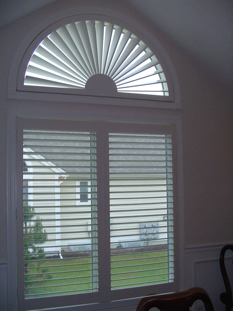 This Cape Cod, MA home has Plantation Shutters in an arch window with matching shutters in the