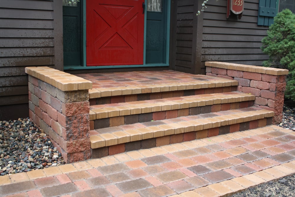 Front stoop overlay with 2 added knee walls capped with pavers matching